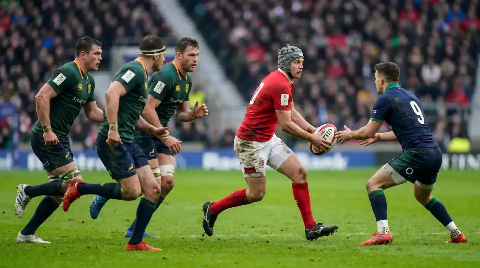 Rugby fly-half receiving a pass and looking to attack the line