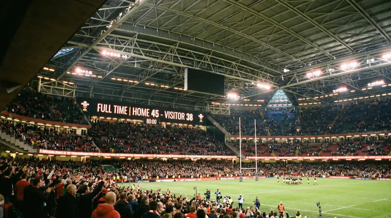 Large rugby stadium scoreboard displaying a high combined points total at full time