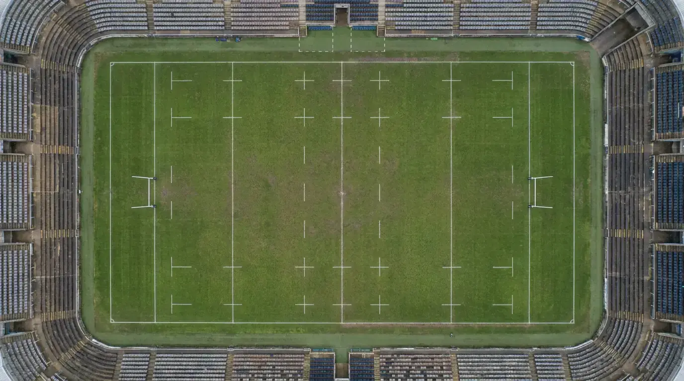 Overhead aerial view of an empty rugby pitch showing the full set of white markings
